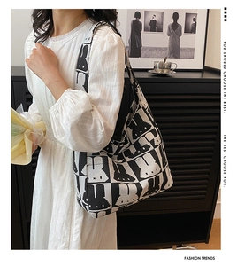 Close-up of black and white pixel rabbit pattern on a large capacity canvas tote bag