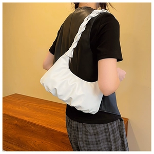 Detailed view of white ruched shoulder bag with chic braided strap and soft leather texture