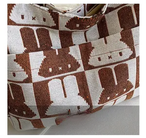 Close-up of jacquard knit texture featuring brown and white rabbit pattern details