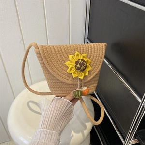 Handwoven sunflower straw bucket bag with cute crochet fruit charms and slim shoulder strap