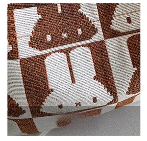 Close-up of high-quality knit fabric showing a brown and white rabbit pattern on a tote bag