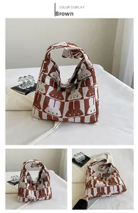 Close-up detail of knitted tote bag with brown checkerboard and cute rabbit pattern