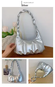 Close-up of silver pleated bag featuring woven strap and metallic glossy finish texture