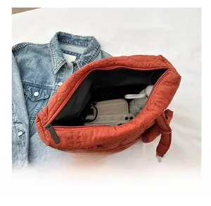 Top view of spacious interior in quilted brick red tote bag with secure zip closure