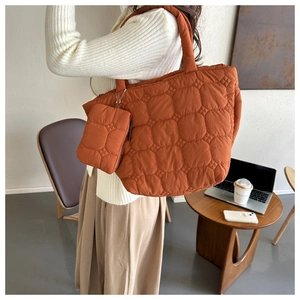 Quilted tote bag set in burnt orange showing side view and matching coin purse