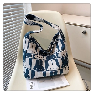 Detailed close-up of knitted rabbit tote bag with blue and white jacquard pattern design