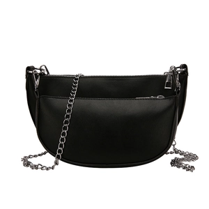 Minimalist black crescent shoulder bag with glossy leather and silver chain strap details