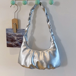 Chic silver metallic pleated hobo bag with a distinctive woven shoulder strap design