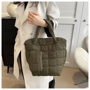 Detailed shot of olive green quilted tote bag set with matching small hanging pouch