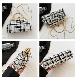Detail view of the elegant tweed plaid pattern and golden metal clasp on a small chain bag