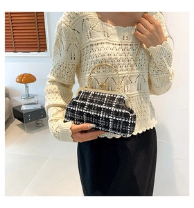 French style tweed handbag with golden metal handle and chain strap worn by a model