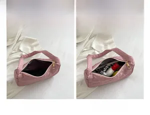 Detail view of pink quilted handbag showing spacious interior and cosmetic storage capacity