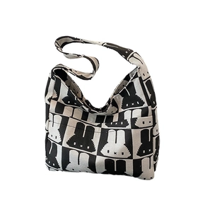Knitted crossbody tote bag with black and white checkerboard pattern and rabbit design