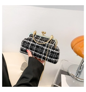 Detail of tweed crossbody bag with golden ring handle and retro spherical metal lock clasp