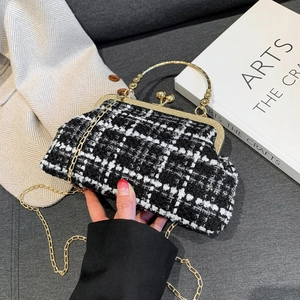 Elegant black and white tweed clutch bag with golden vintage clasp and metal chain strap