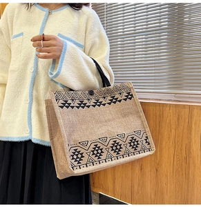 Detail showing the linen tote bag's ethnic pattern and durable fabric texture