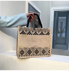 Detail of linen tote bag showing ethnic geometric patterns and button closure