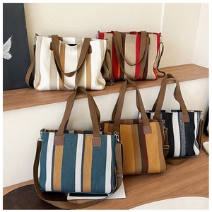 Detailed view of striped canvas tote bags in five colors with adjustable shoulder straps
