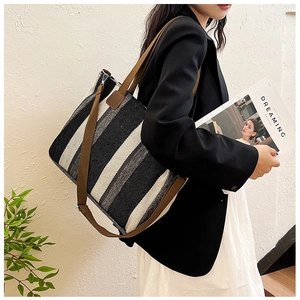 Large capacity tote bag with vertical grey and black stripes and leather straps