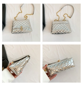 Detail of silver quilted crossbody bag with gold chain strap and rectangular metallic clasp