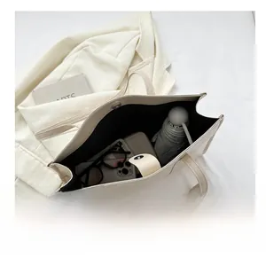 Macro view showing large capacity of cream leather tote bag with interior storage space