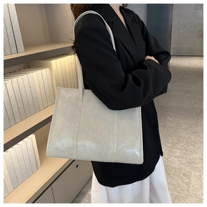 Detail view of cream vintage tote bag showing soft oil wax leather texture and stitching