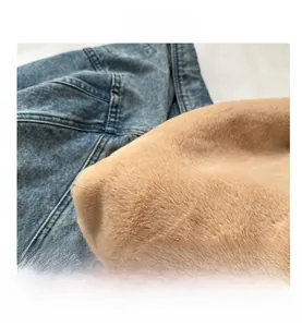 Close-up detail of plush faux fur lining and premium denim fabric with fine stitching