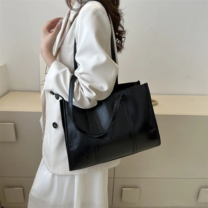 Minimalist black oil wax leather tote bag for women with double handle and shoulder straps