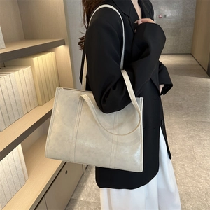 Minimalist cream white oil wax leather tote bag with vertical stitching for daily commuting