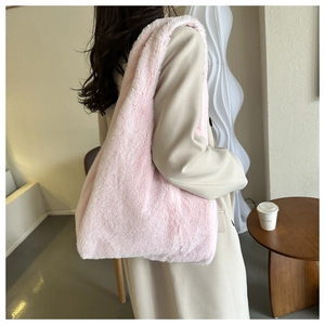 Detail view of the soft pink plush faux fur tote bag showing texture and shoulder strap