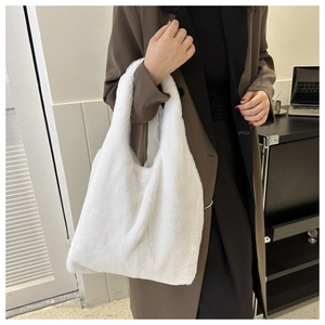 Close-up of fluffy white faux fur shoulder bag showing soft texture and large capacity