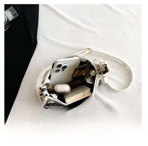 Top view of open plaid tweed crossbody bag showing spacious interior with daily essentials