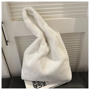 Close-up of white plush tote bag showing soft faux fur texture and wide handle