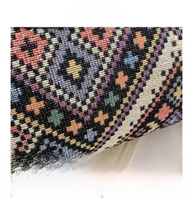 Macro shot of colorful bohemian woven fabric with intricate geometric ethnic patterns