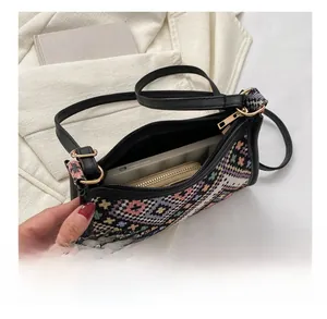 Interior view of ethnic woven shoulder bag showing storage space for phone and wallet