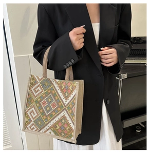 Detail showing the colorful ethnic geometric pattern on the woven linen handbag