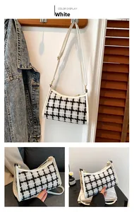Detail of white plaid tweed shoulder bag with leather strap and elegant curved design