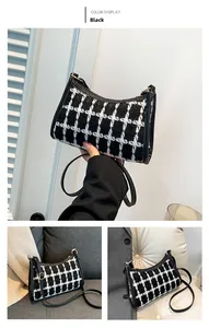 Detail of black and white tweed plaid small shoulder bag with leather piping accents