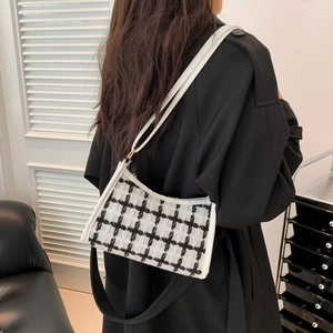 Fashionable black and white plaid tweed shoulder bag with white leather straps