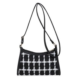 Fashionable black and white plaid crossbody bag with gold hardware and a shoulder strap