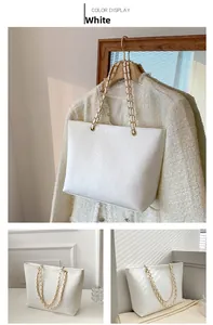 Détail du sac cabas blanc en cuir à texture crocodile avec bandoulière en chaîne dorée