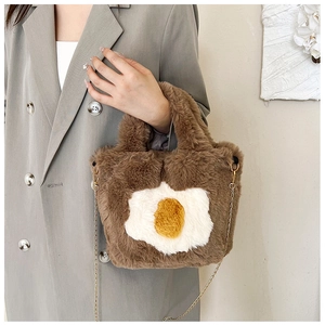 Detailed view of plush fried egg crossbody bag with golden chain and soft faux fur texture