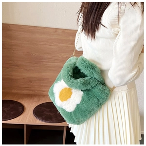 Detail view of the soft green faux fur crossbody bag with a large egg flower pattern
