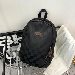 Minimalist black checkerboard backpack with leather logo patch and waterproof fabric