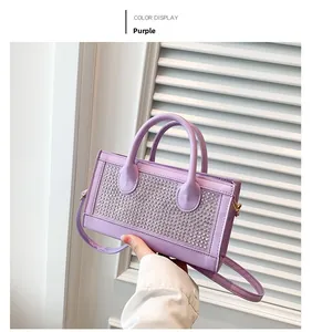 Detail of purple rhinestone handbag with shimmering crystals and elegant silver handles