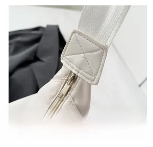 Detail shot of the durable nylon fabric with reinforced diamond stitching and metal zipper