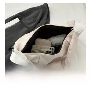 Spacious interior of the beige nylon crossbody bag showing daily essentials capacity