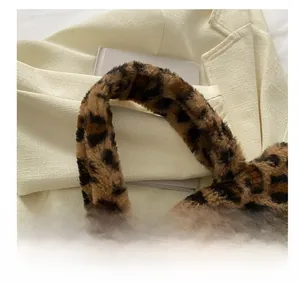 Detail of the leopard print faux fur handbag featuring the soft plush handle and texture