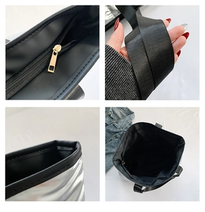 Detalle del bolso tote plateado que muestra la cremallera dorada y la textura acolchada