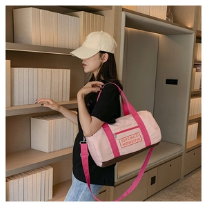Detailansicht der pink-braunen Sporttasche mit verstellbarem Schultergurt im Regal